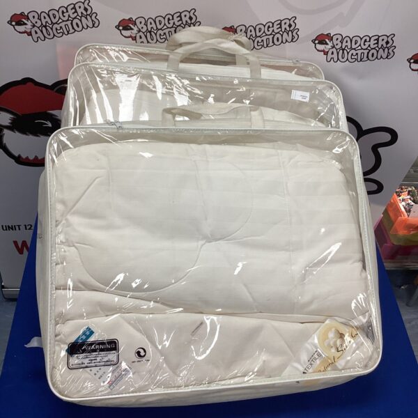 Lot of four bagged duvets for bedding and home textiles.