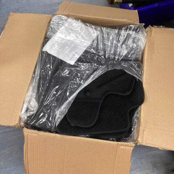 New car floor mats in packaging, automotive interior protection.