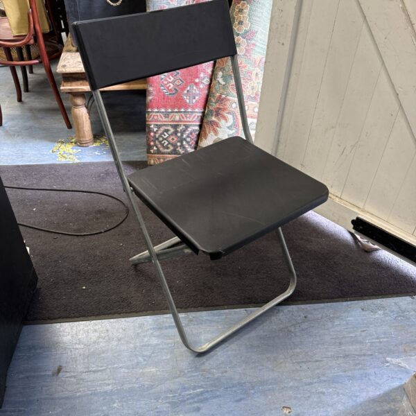 Black IKEA Jeff folding chair, minimalist design, space saving.