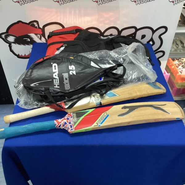 Mixed sports lot including cricket bats and tennis racket cases.