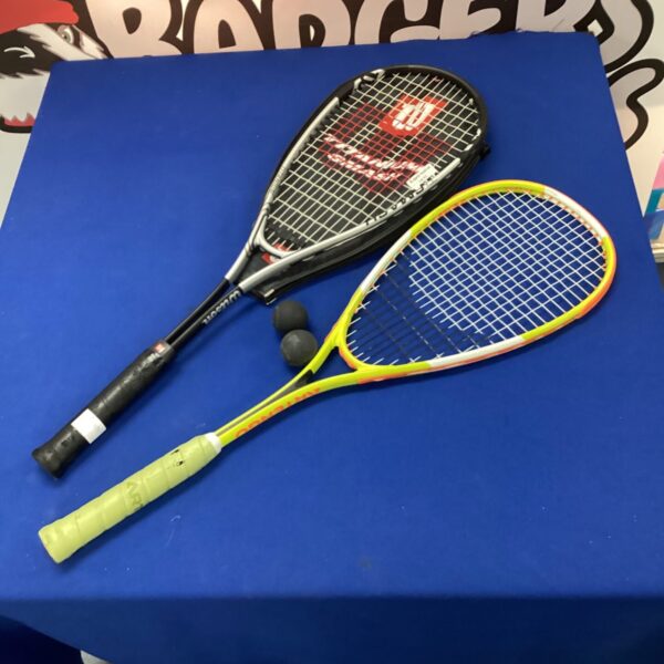 Two squash rackets and balls for indoor court sport.