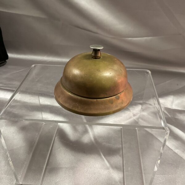 Vintage brass reception bell with aged patina.