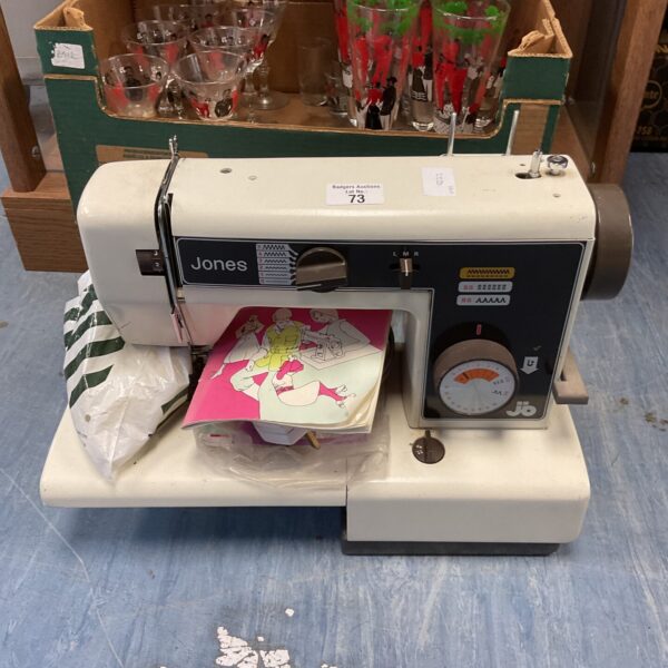 Vintage Jones electric sewing machine with power cable and pedal.