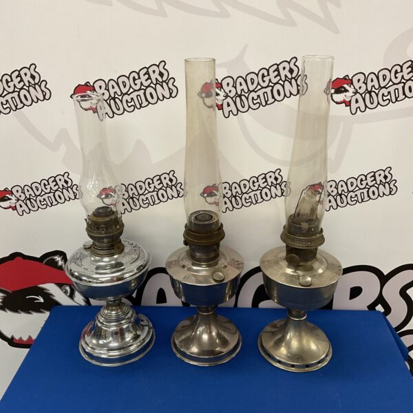 Three vintage Aladdin paraffin lamps with brass bases.
