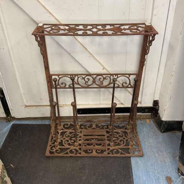 Antique cast iron boot tree with decorative pierced design.