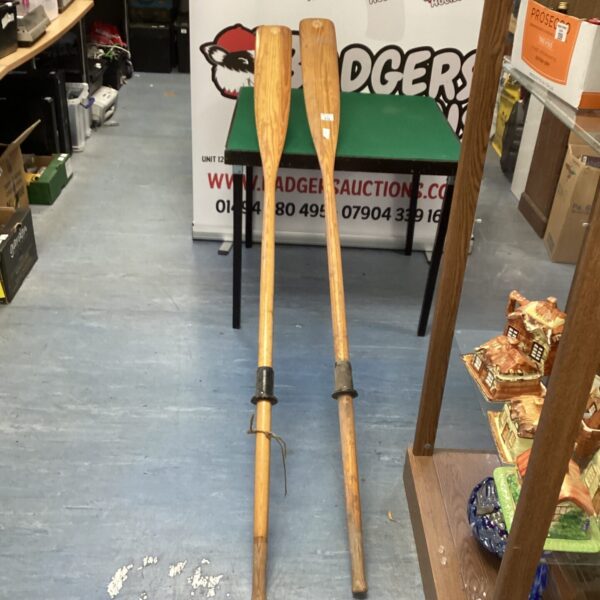 Pair of vintage wooden oars for nautical decor.