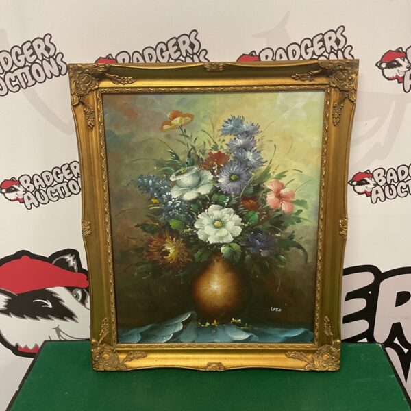 Vintage oil painting of flowers signed Laro, a beautiful floral still life.