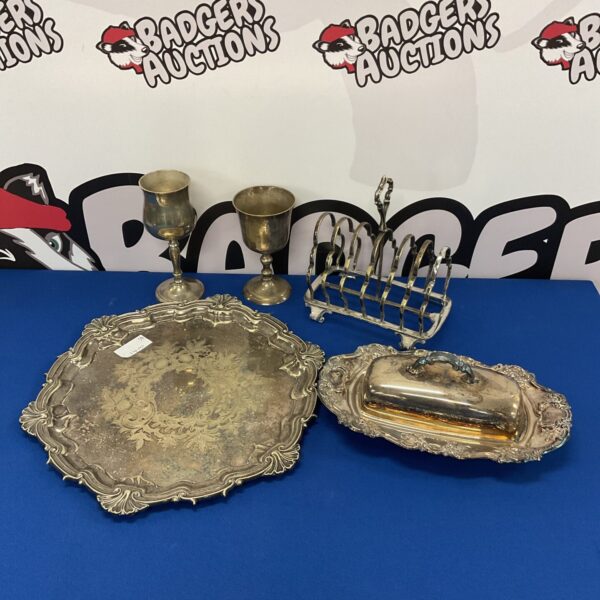 Antique silver plate tray and toast rack set on display.