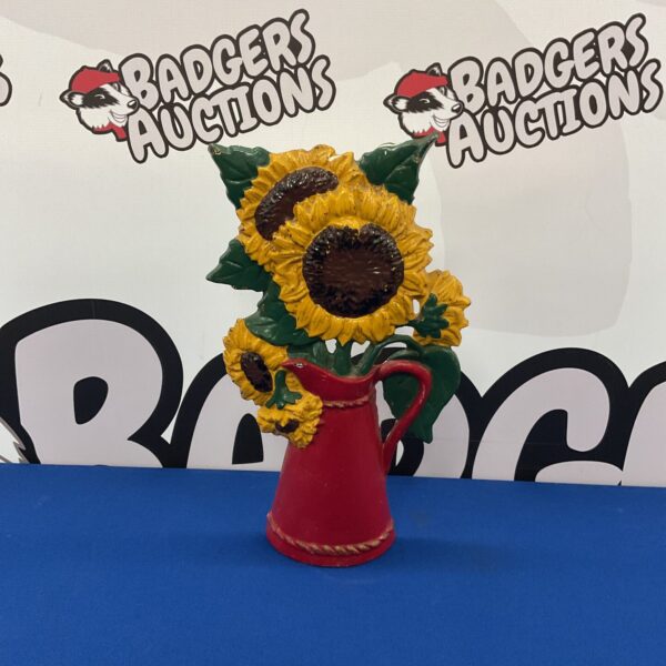 Vintage cast iron sunflower doorstop for farmhouse decor.