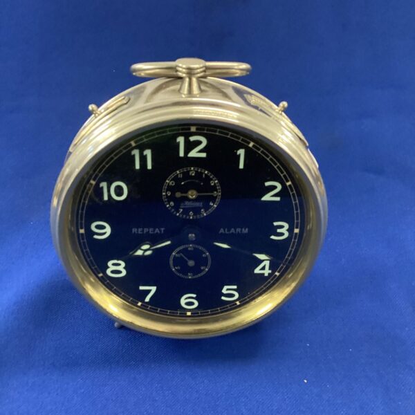 Vintage Kaiser alarm clock with bold numerals and mechanical movement.