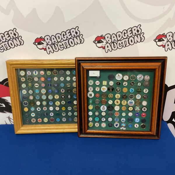 Framed collection of colourful golf ball markers for collectors.