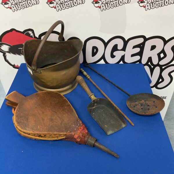 Vintage brass coal scuttle with fireplace tools and bellows.