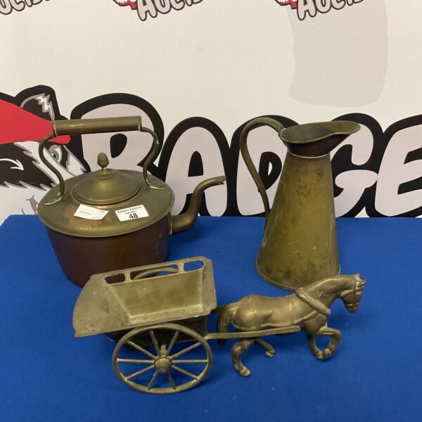 Vintage brass kettle, pitcher, and horse cart collectible display.