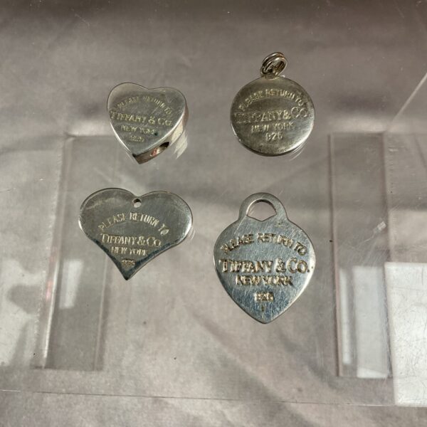 Close-up of four vintage Tiffany style floral pendants.