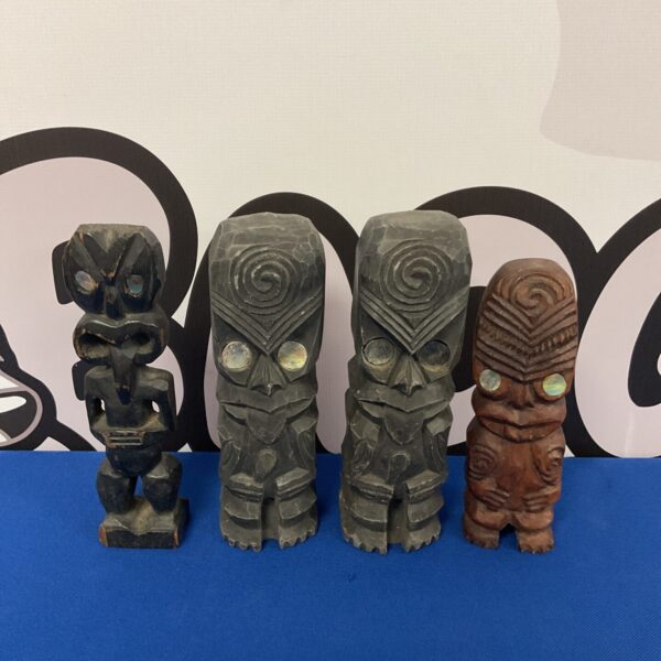 Set of four small wooden totem poles, tribal art.