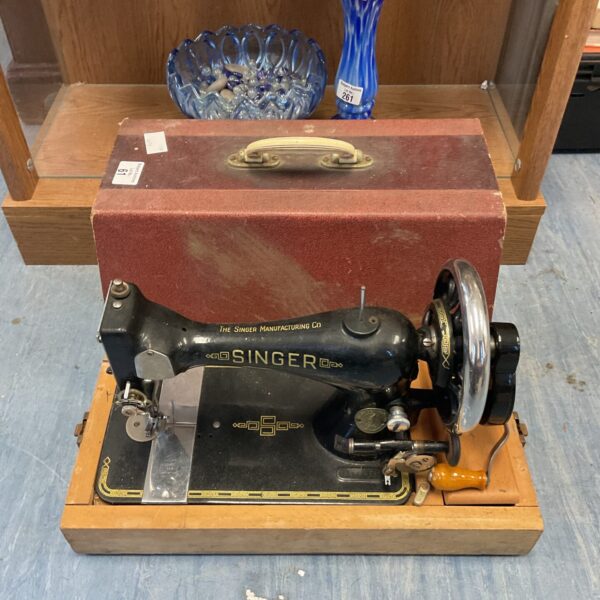 Vintage Singer Model 28 hand crank sewing machine with floral details.