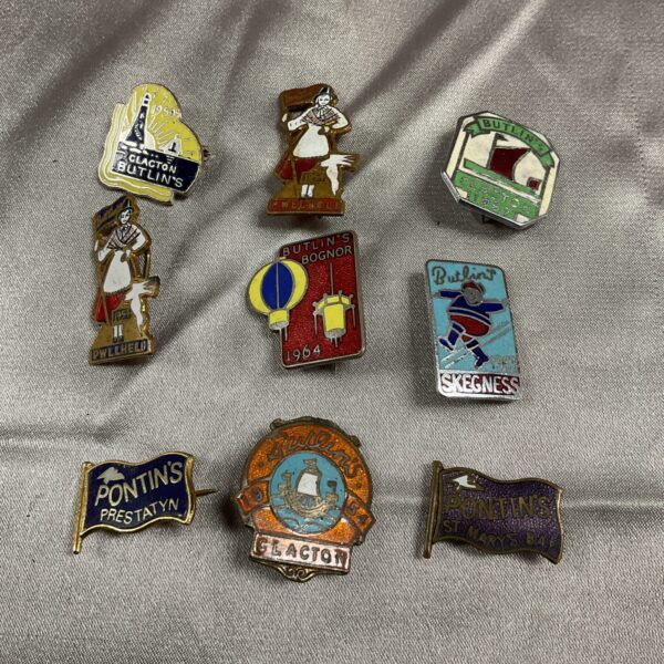 Vintage Butlins and Pontins badges in a collectible lot.