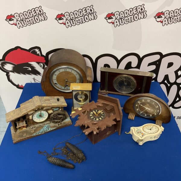 Vintage clock lot featuring various antique timepieces.