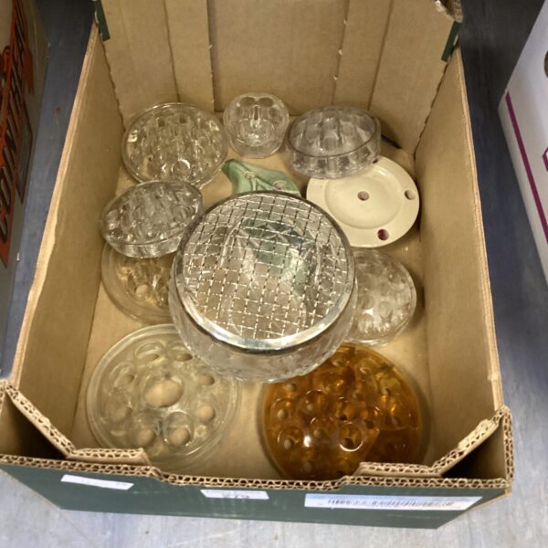 Vintage flower frog holders in a box, glass floral arranging supplies.