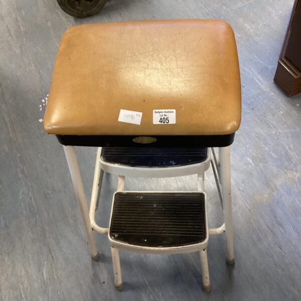 Vintage leather stap ladder with worn seat.