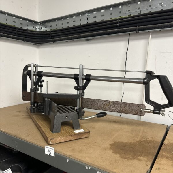 Vintage mitre hand saw with adjustable box for accurate cuts.