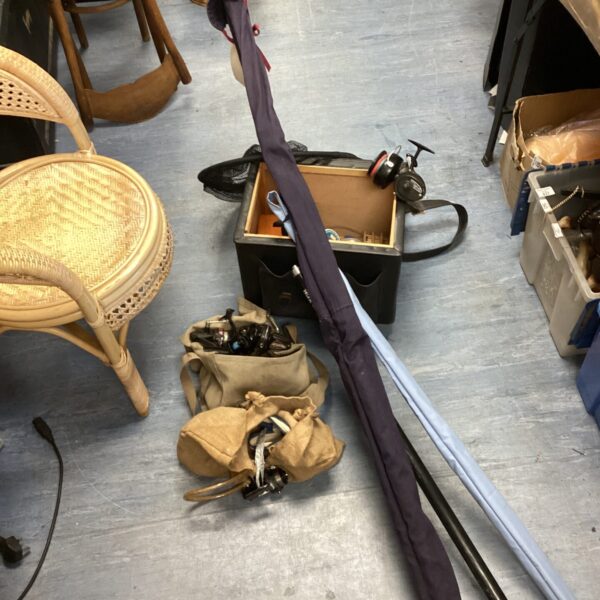 A collection of fishing rods, reels, and a tackle box for angling.