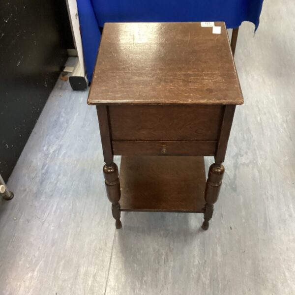 Vintage wooden occasional table with drawer, side view.