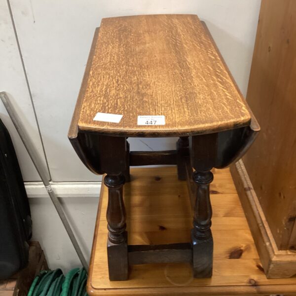 Antique oak drop leaf coffee table with turned legs.