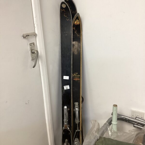 Vintage ski sets including Rossignol and Pionies Master hickory skis.