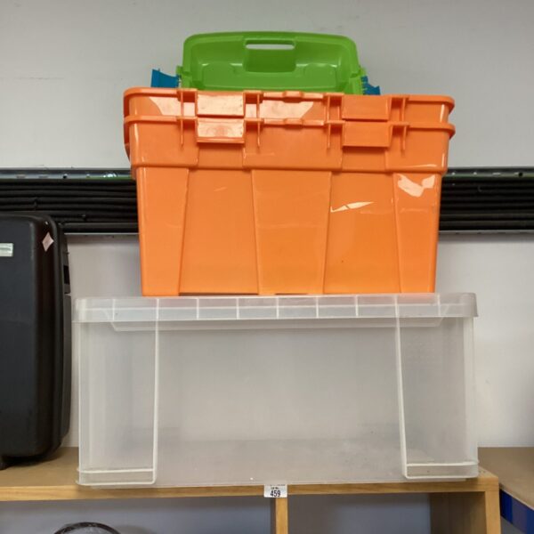 Lot of three colourful plastic storage boxes for household organisation.