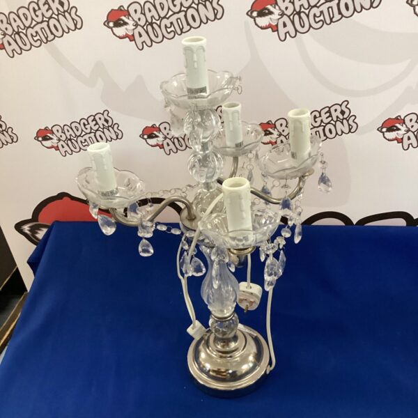 Vintage crystal table lamp with ornate design.