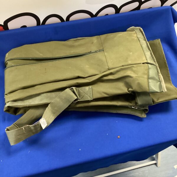 Green Trakker fishing rod bag for angling equipment.