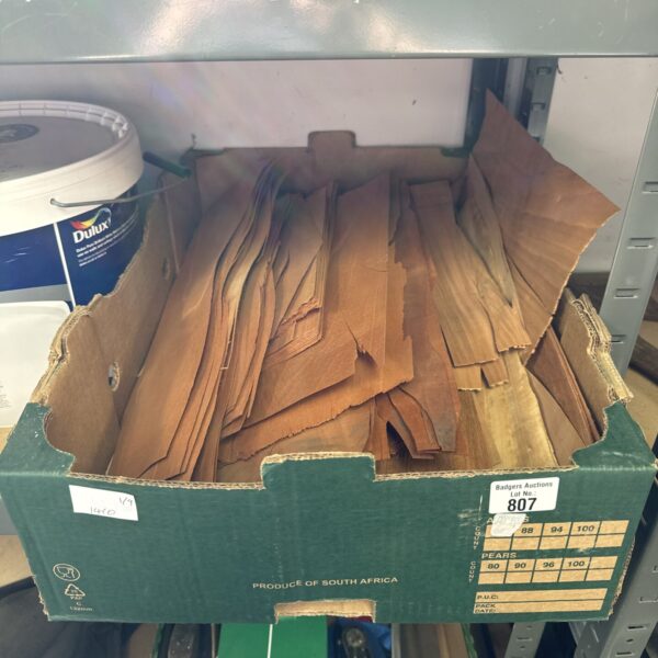 Quantity of wood veneer strips for furniture restoration projects.