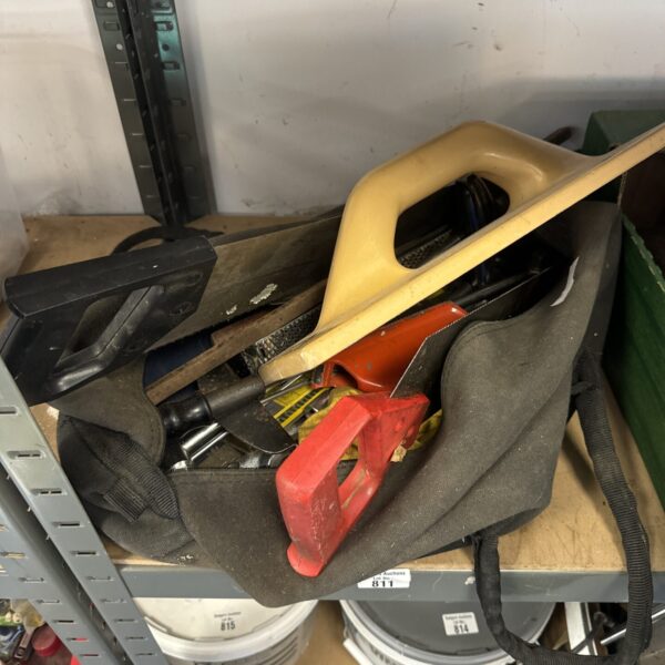 Canvas tool bag filled with assorted vintage hand tools.
