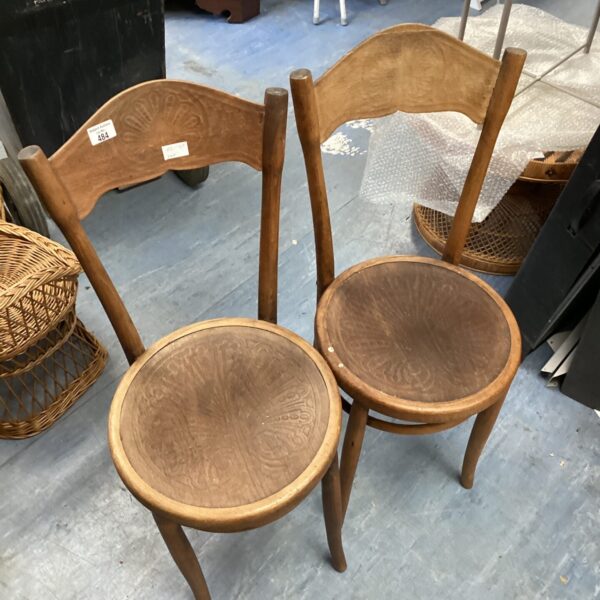 Pair of antique bentwood chairs with curved backs.