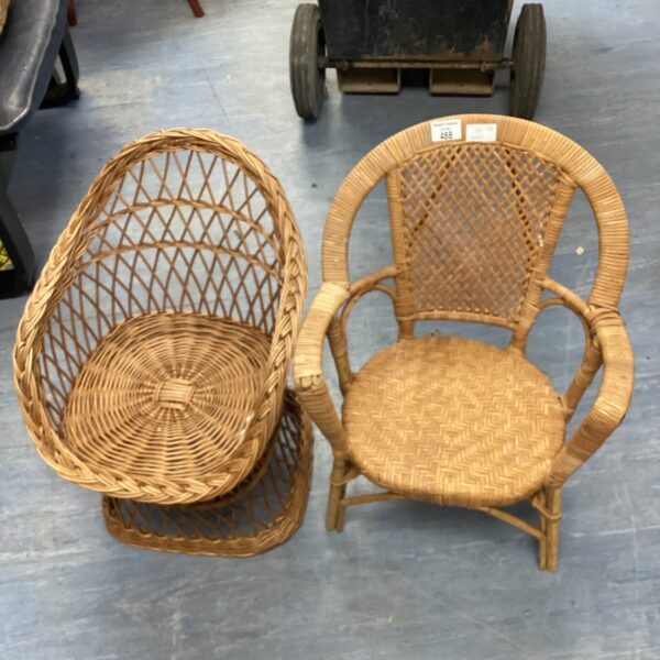 Two vintage childrens wicker chairs with woven rattan construction.