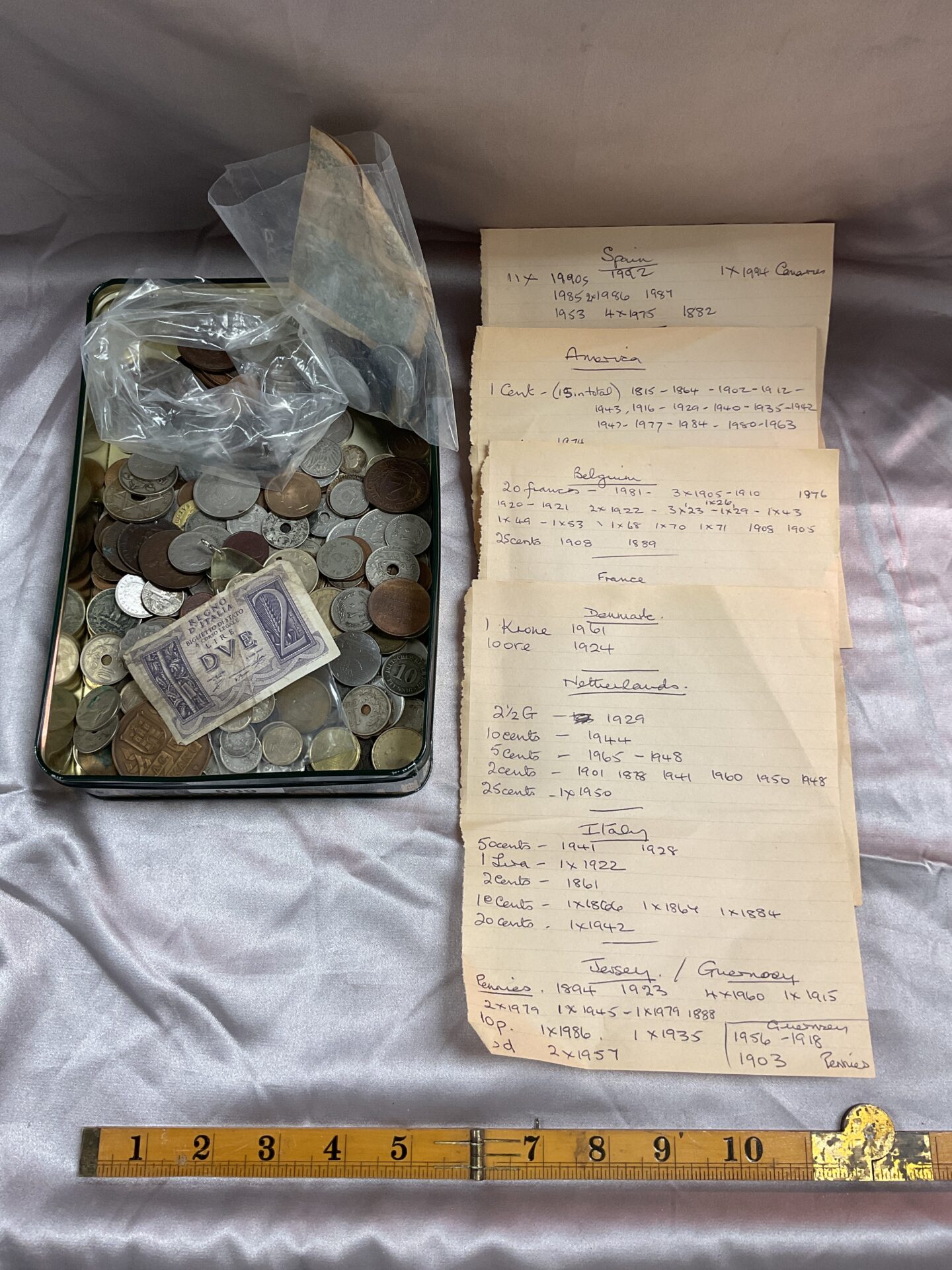 639 Tin of assorted foreign coins and some notes