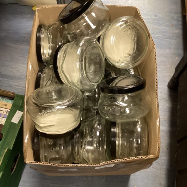 Lot of clear glass pickling jars for preserving food.