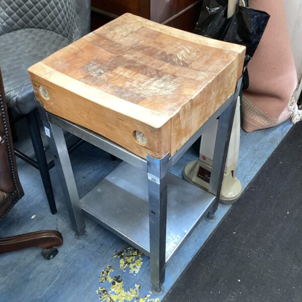 Vintage butchers block with metal frame and worn wooden surface.