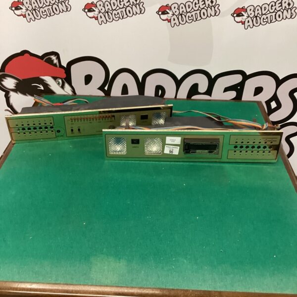 Vintage cassette deck with radio controls and black finish.