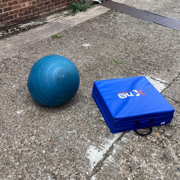 Used exercise mat and inflatable ball for home fitness.