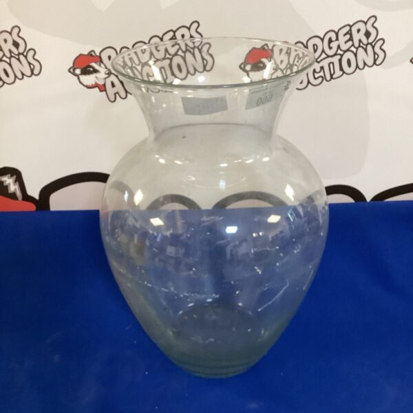 Large clear glass vase for floral arrangements and home decor.