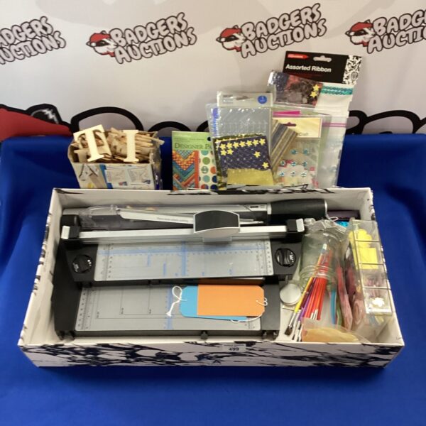 Mixed arts and crafts lot with paper trimmers and ribbons.
