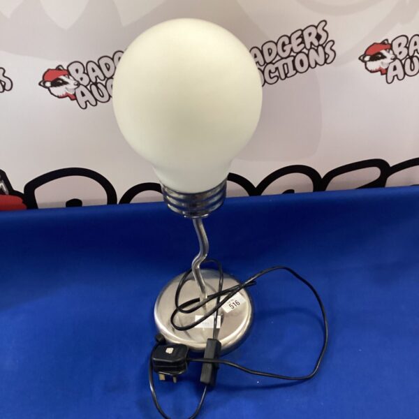 Modern desk lamp with a light bulb design, ideal for home or office.