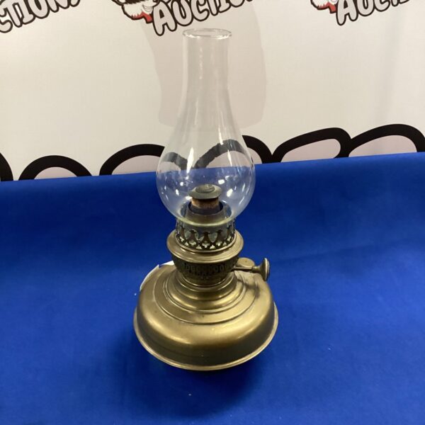 Vintage Wellington paraffin lamp with brass base and glass shade.
