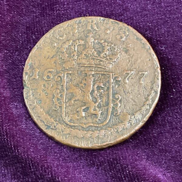 Antique Swedish 1 Ore coin from 1677, showing the obverse design.