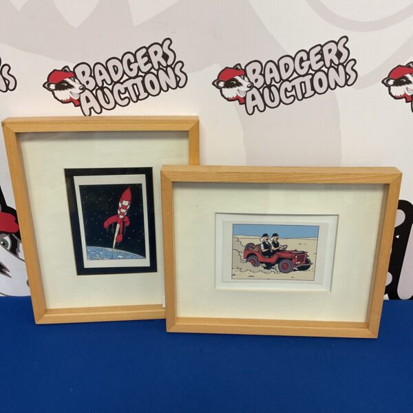 Pair of vintage Tintin cartoon prints in simple frames.