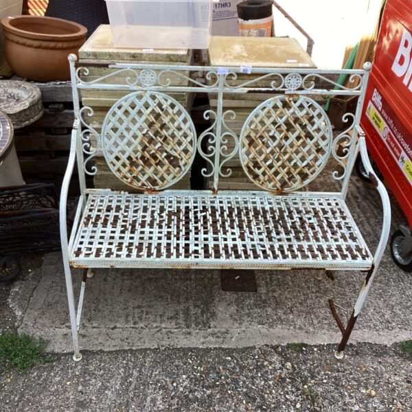 Vintage wrought iron metal garden seat requiring repair for garden use.