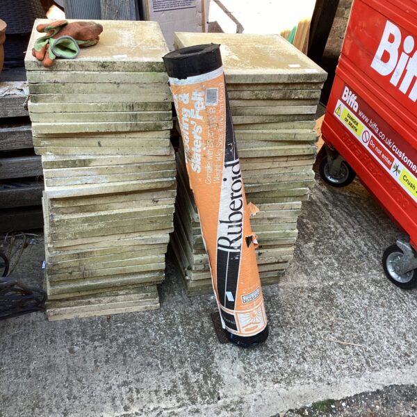 Stack of ruberoid roofing felt rolls for building damp proofing.