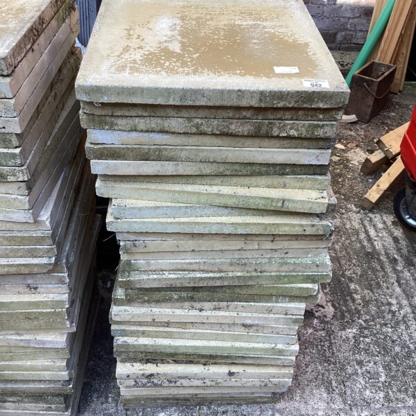 Stack of weathered concrete paving slabs for garden use.